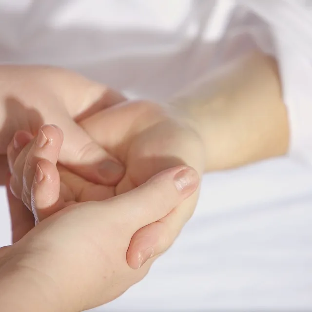 Hands treating a patient's wrist