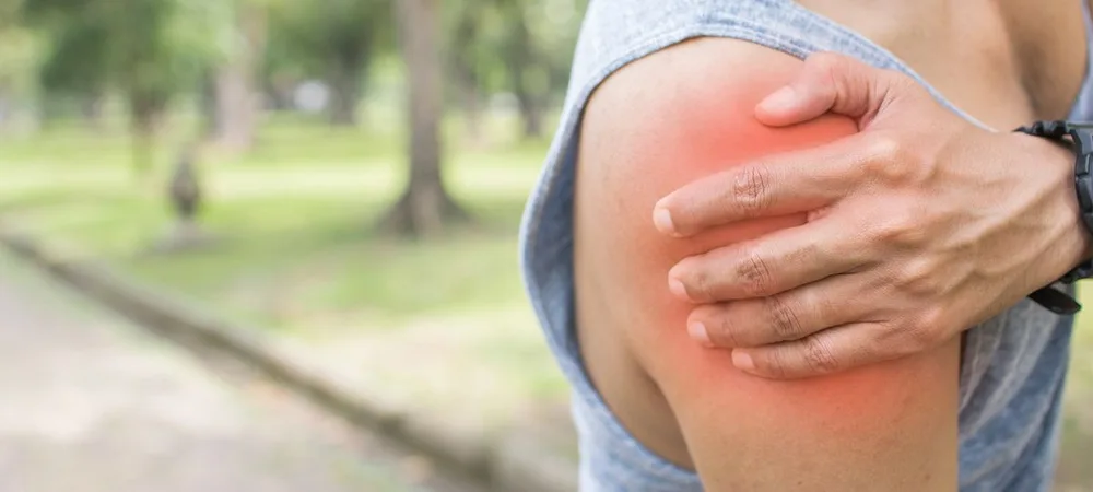 Patient holding a painful shoulder